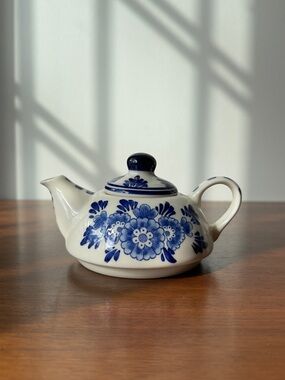 A mini hand painted teapot by Delft Blue.